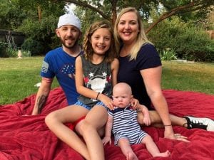 Matt sitting outside with his family