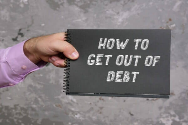 HOW TO GET OUT OF DEBT sign on the page.